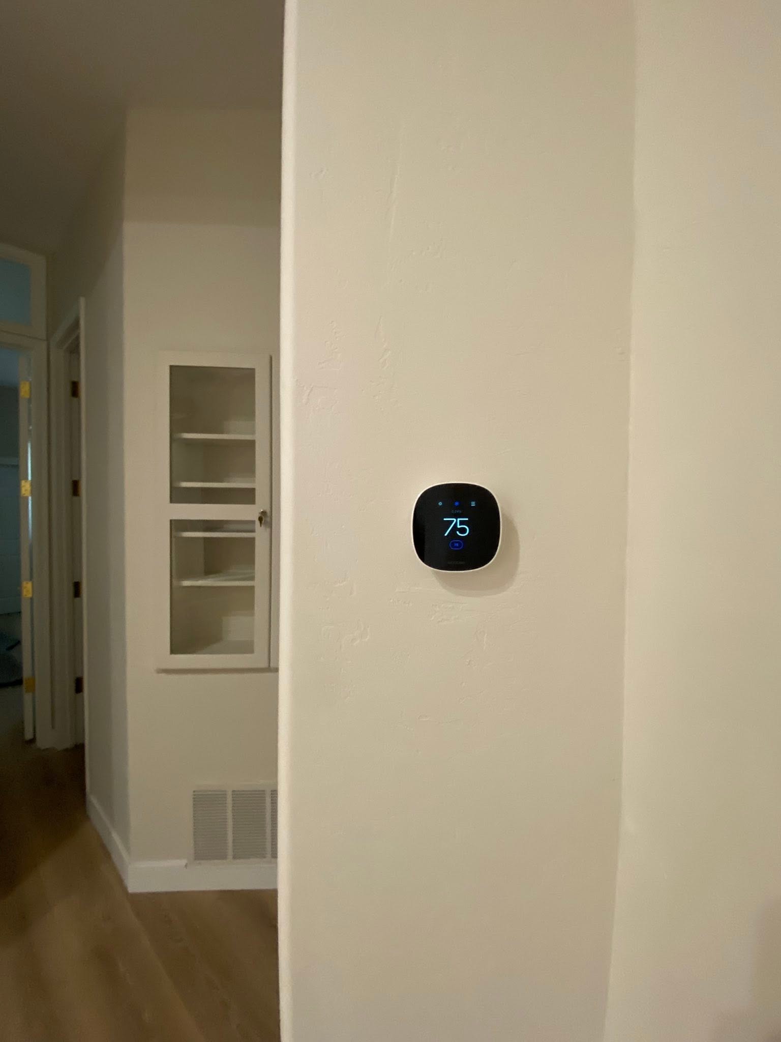 Smart thermostat on wall